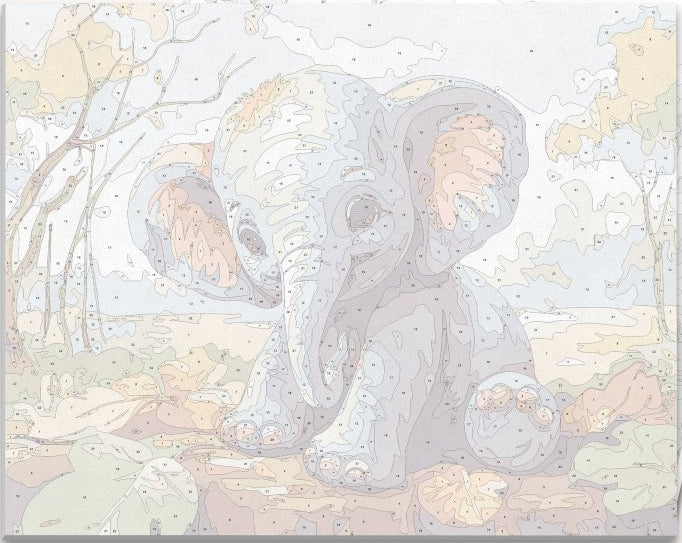 A young elephant with large ears and big eyes sits playfully on a pile of autumn leaves, its trunk resting gently on the ground..