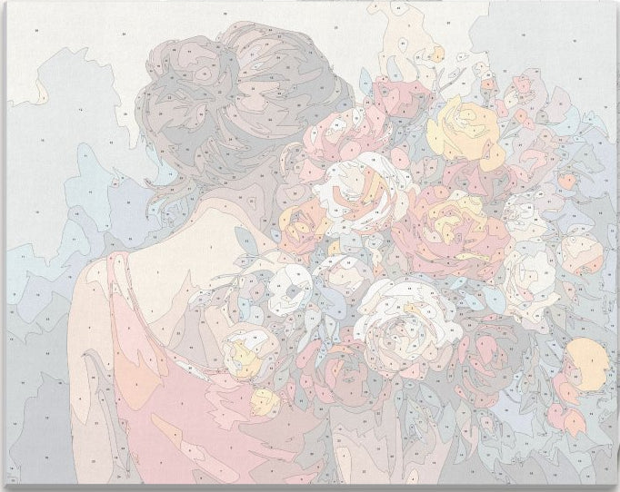 A woman stands among a vibrant array of flowers in full bloom.